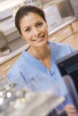 A Nurse Sitting At A Computer