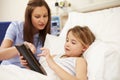 Nurse Sitting By Girl's Bed In Hospital With Digital Tablet Royalty Free Stock Photo