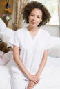 Nurse Sitting On Hospital Bed