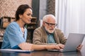 Nurse sitting by senior man Royalty Free Stock Photo