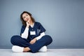 Nurse, sitting or thinking of hospital treatment, medicine innovation or surgery planning on mock up wall. Doctor, woman Royalty Free Stock Photo