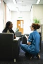 Nurse speaking to a patient in the waiting room Royalty Free Stock Photo