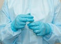 Nurse in sterile gown and gloves with an ampoule with is ready to open it