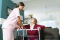 Nurse Supporting Senior Disabled Patient At Home