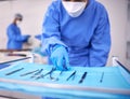 Nurse, surgery and prepare tools in operation, medical equipment and scissors for procedure. Surgeon, hospital and