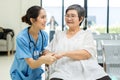 Nurse take care Elderly patient in hospital ward. Elderly woman sit down at hospital Royalty Free Stock Photo