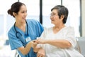 Nurse take care Elderly patient in hospital ward. Elderly woman sit down at hospital Royalty Free Stock Photo