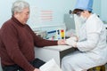 Nurse takes blood specimen for test