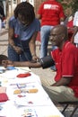 A nurse takes a man blood pressure