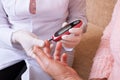 Nurse takes test for sugar in blood of elderly Royalty Free Stock Photo