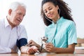 Nurse taking blood pressure Royalty Free Stock Photo