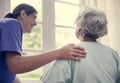 Nurse taking care of an old woman Royalty Free Stock Photo