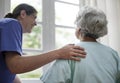 Nurse taking care of an old woman Royalty Free Stock Photo