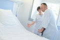 Nurse taking care patient in hospital room Royalty Free Stock Photo