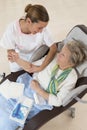 Nurse taking care of senior woman in retirement home