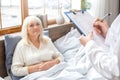 Nurse taking care of senior woman writing prescription retirement concept Royalty Free Stock Photo