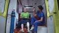 Nurse and sick girl in ambulance car.