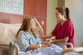 Nurse Talking To Female Teenage Patient In Hospital