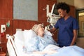 Nurse Talking To Senior Female Patient In Hospital Bed Royalty Free Stock Photo