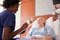 Nurse Talking To Senior Female Patient In Hospital Bed Royalty Free Stock Photo