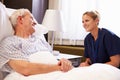 Nurse Talking To Senior Male Patient In Hospital Bed Royalty Free Stock Photo