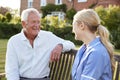 Nurse Talking To Senior Man In Residential Care Home