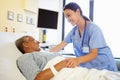 Nurse Talking To Senior Woman In Hospital Room Royalty Free Stock Photo
