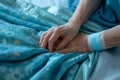 Nurse touching elderly patient hand in a comforting gesture, people living with parkinson picture