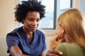 Nurse Treating Teenage Girl Suffering With Depression