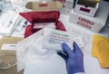 Nurse unpacking box with Covid-19 PCR kit in hospital warehouse