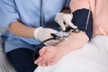 Nurse using blood pressure meter