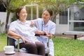 Nurse using stethoscope checking to Asian senior woman patient for listening heart rate at home