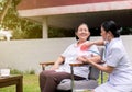 Nurse using stethoscope checking to asian senior woman patient for listening heart rate at home Royalty Free Stock Photo