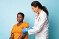 Vaccinated African American Lady And General Practitioner Making Vaccination, Studio