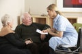 Nurse visiting senior couple at home Royalty Free Stock Photo