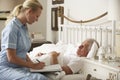 Nurse Visiting Senior Male Patient In Bed At Home