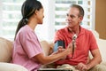 Nurse Visiting Senior Male Patient At Home Royalty Free Stock Photo