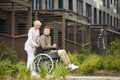 Nurse walking with patient in wheelchair Royalty Free Stock Photo