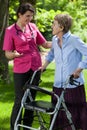 Nurse walking with a woman with a walker