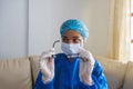 Nurse wearing a mask and removing glasses in the hospital