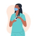Nurse wearing a medical mask measures the oxygen level in the blood with a finger pulse oximeter