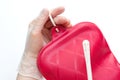 Nurse wearing sterile rubber gloves holds Cleansing Enema Bucket Set on white background. Enema Mug Royalty Free Stock Photo