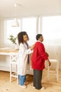 Nurse wearing uniform using stethophone while examining woman