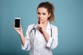 Nurse in white coat showing blank smartphone screen Royalty Free Stock Photo