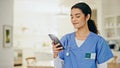 Nurse, woman and phone at nursing home, social media post and networking for healthcare or medical service. ADN student