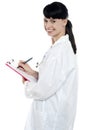 Nurse writing fresh prescription for the patient Royalty Free Stock Photo