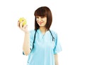 Nurse or young doctor with apple, smiling Royalty Free Stock Photo