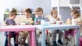 Nursery babies eating food. Kids have lunch in daycare