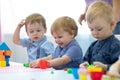 Nursery kids playing with play clay at kindergarten or playschool Royalty Free Stock Photo