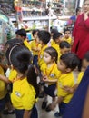 Nursery kids of a school visiting shops,atm,etc to get acknowledged of varoous social institution.